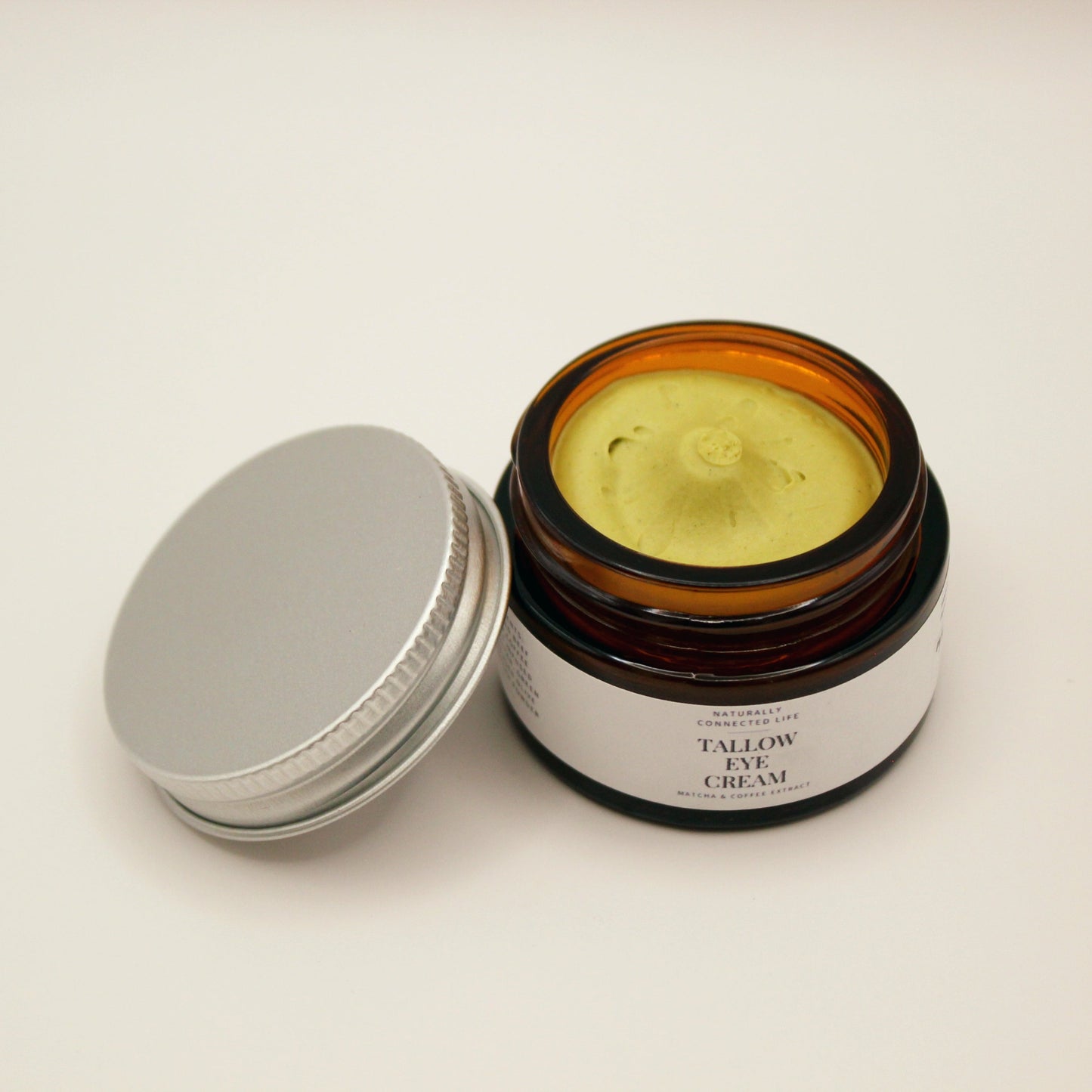 Tallow eye cream in a glass jar from naturally connected life, natural under eye cream, reduce puffiness and brighten dark circles naturally