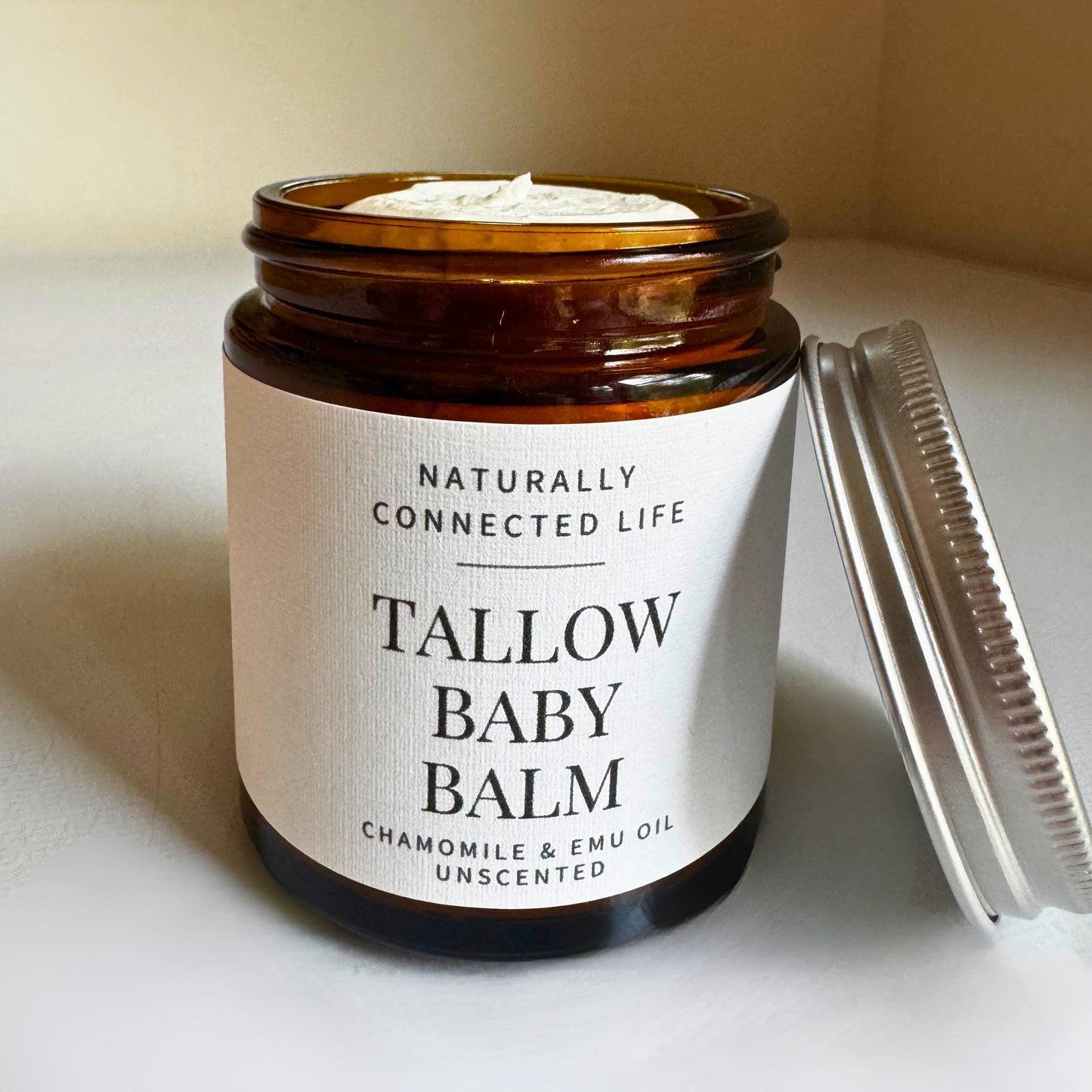 Glass jar of tallow baby balm, natural diaper balm, organic baby balm, naturally connected life tallow lotion for  babies