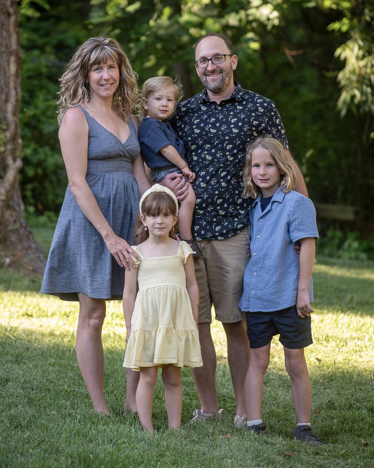 The family behind Naturally Connected Life, standing together outdoors in the Asheville area