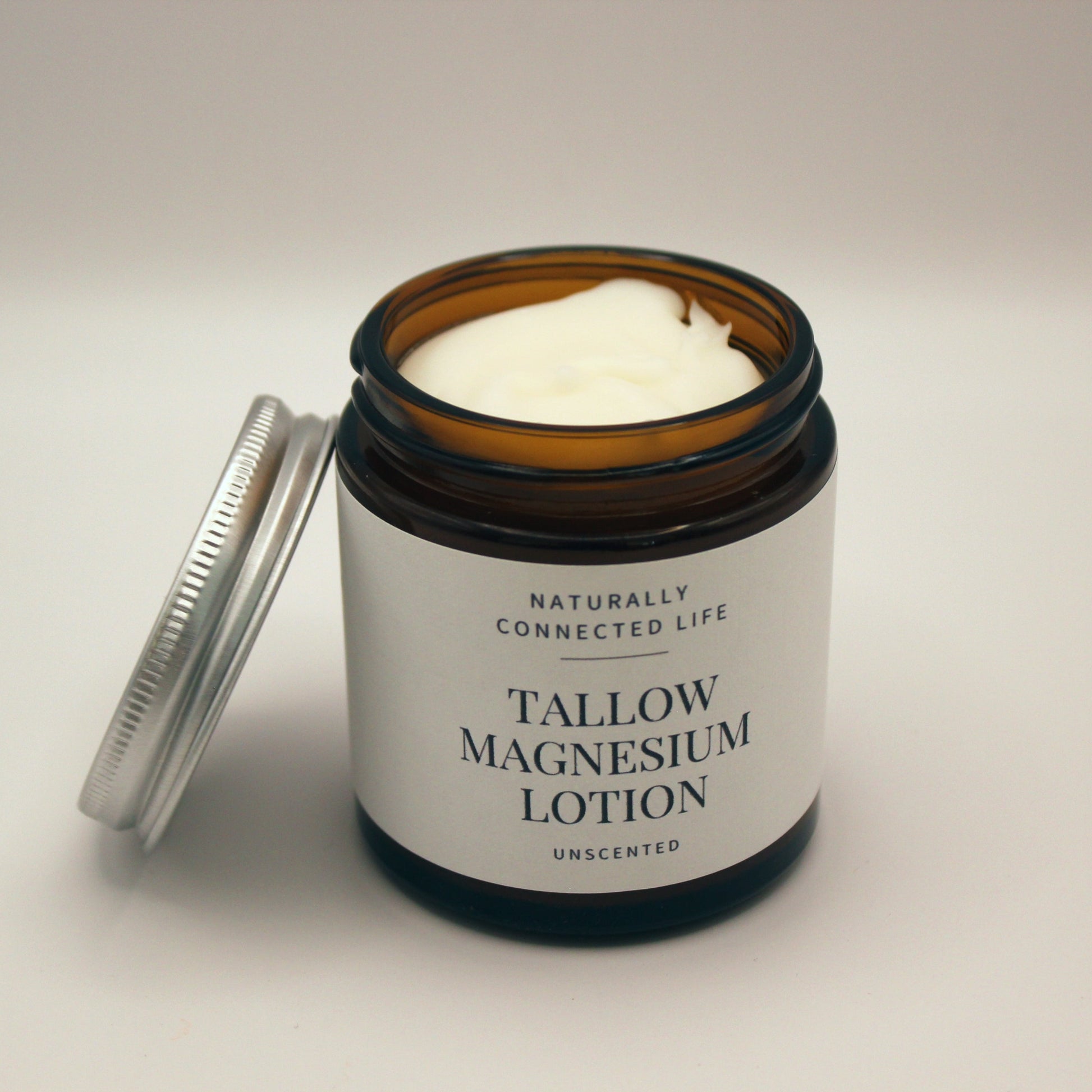Glass jar of tallow magnesium lotion from naturally connected life, relieve cramping muscles with magnesium lotion, natural sleep remedy